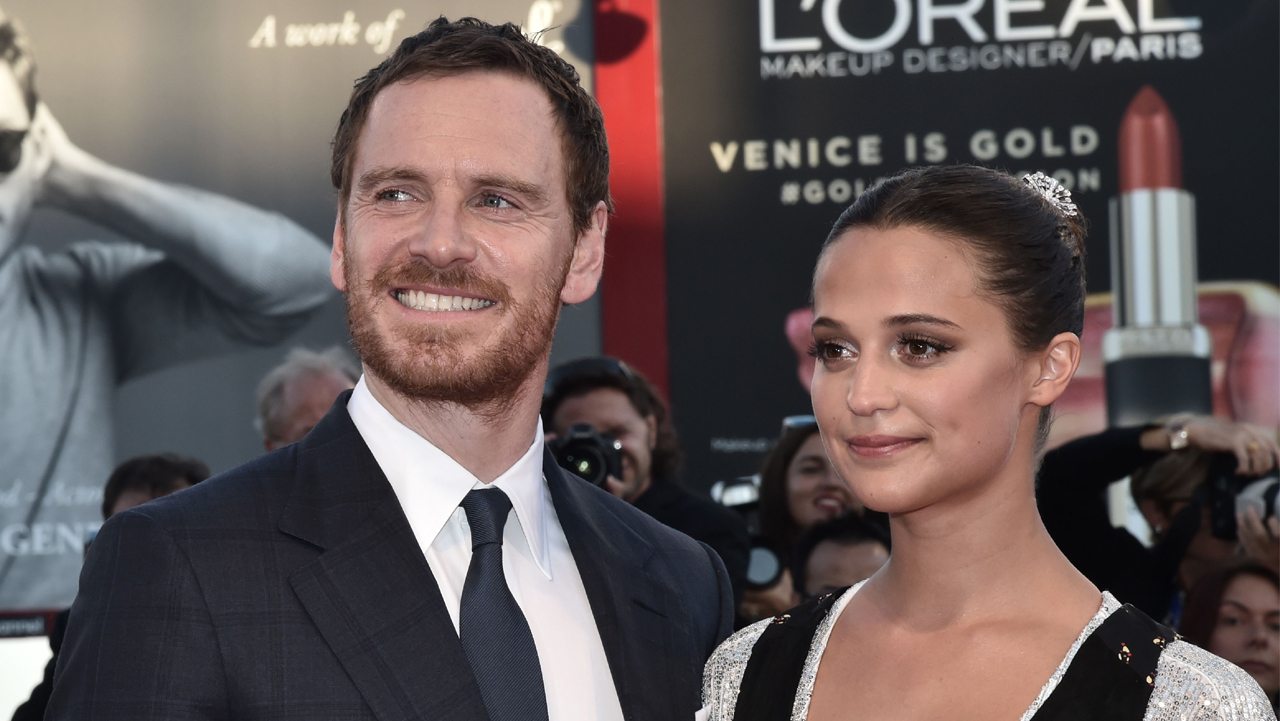 British actor Michael Fassbender and Swedish actress Alicia Vikander pose on the red carpet before the premiere of the movie "The Light Between Oceans" presented in competition at the 73rd Venice Film Festival on September 1, 2016 at Venice Lido. / AFP / TIZIANA FABI (Photo credit should read TIZIANA FABI/AFP/Getty Images)